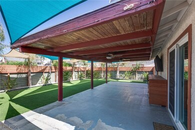 Fenced backyard with a patio, a putting green, and
