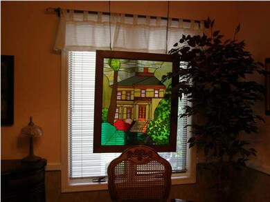 View 2 of the dining room. The framed stained glas