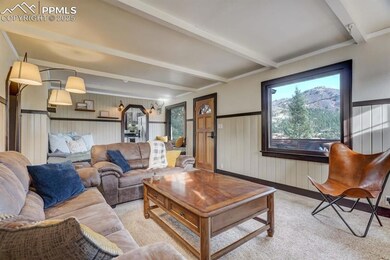 Living room with light carpet and beam ceiling
