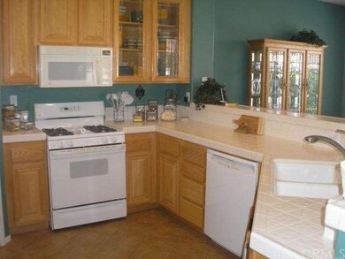 Lovely oak cabinets with tile counter