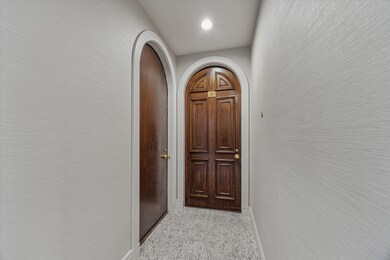 There is an arched entry from the hallway to unit