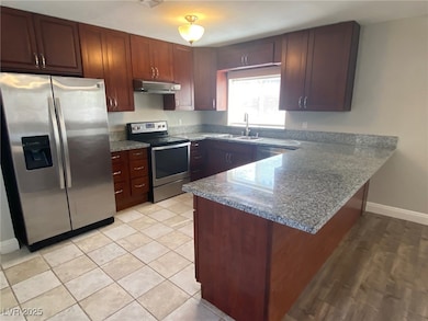 Kitchen featuring stainless steel appliances, a si