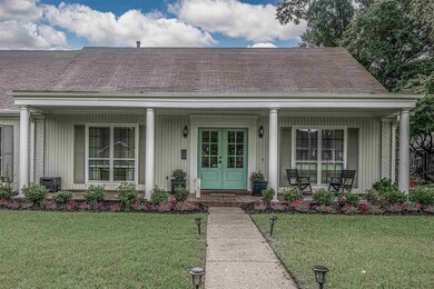 View of front of house with a porch, central AC un