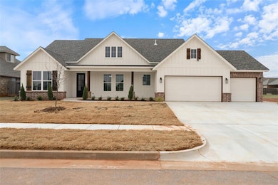 Modern farmhouse with concrete driveway, brick sid
