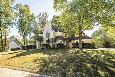 French country inspired facade with a front yard