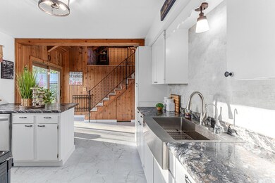 Renovated kitchen with stainless steel appliances.