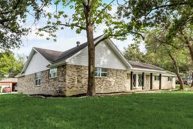 View of side of home featuring a yard