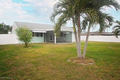 Rear view of house with a lawn