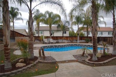 View of pool and backyard from back door
