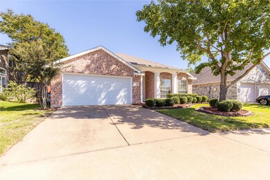View of front facade featuring a front yard and a garage