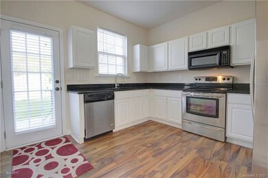 KITCHEN: The upgraded laminate floors continue int