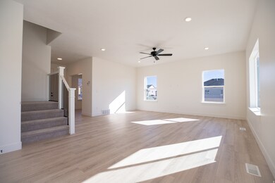 Large family room with ceiling fan.