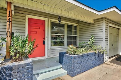 Doorway to property featuring a garage and a porch