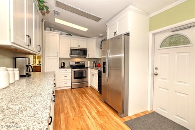 Kitchen featuring stainless steel appliances, whit