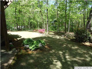 Back yard is wooded and beautifully landscaped.
