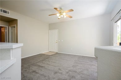 Carpeted empty room featuring baseboards, visible