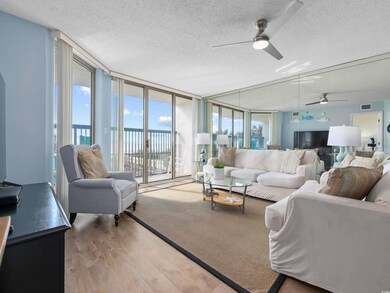 Living area with visible vents, a wall of windows,