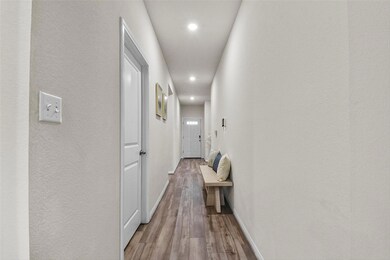 Hallway featuring light wood-style flooring, rece