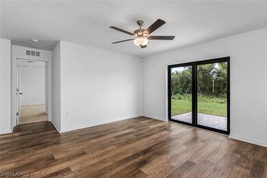 Unfurnished room with dark hardwood / wood-style f