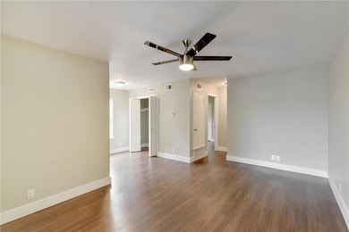 Unfurnished room with baseboards, ceiling fan, da