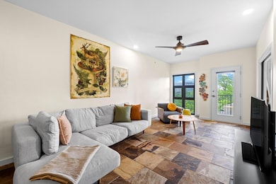 Living room with stone finish flooring, ceiling f