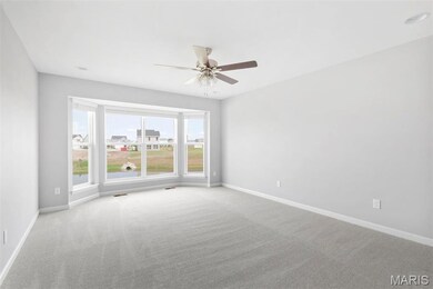 Carpeted spare room with ceiling fan