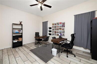 Office space with ceiling fan and light hardwood / wood-style floors