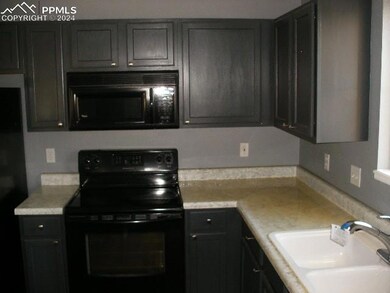 Kitchen with black appliances and sink