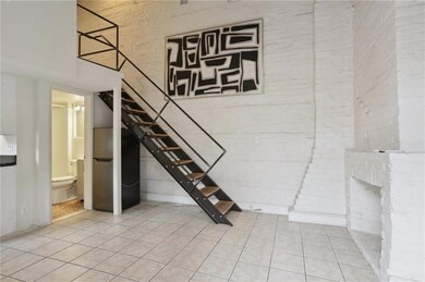 Exposed brick walls with a high ceiling