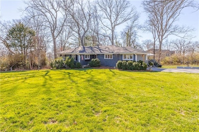 Single story home with a front lawn