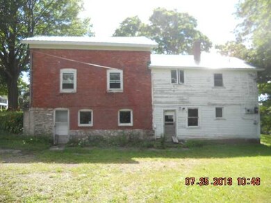 Exterior Back. The door at the back by the brick i