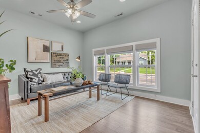 Another view of the front living room with a ceiling fan, tall ceilings and beautiful LVT floors ~