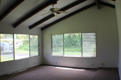 Open Beam, sunken-in living room with large picture windows allowing lots of natural light.