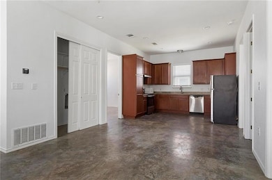 Kitchen with stainless steel appliances, baseboar