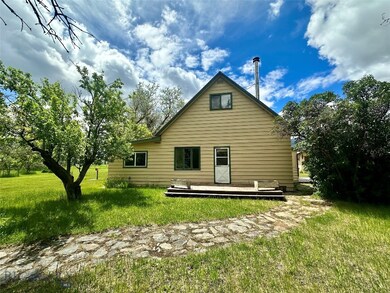 Back of house featuring a lawn