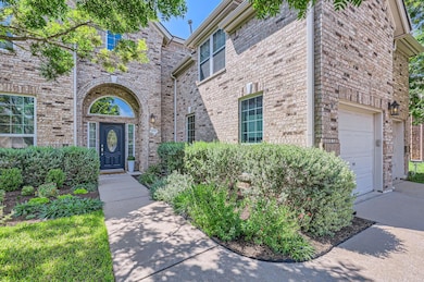 Doorway to property with a garage, brick siding, 