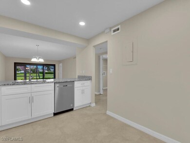 Kitchen with light stone countertops, dishwasher,