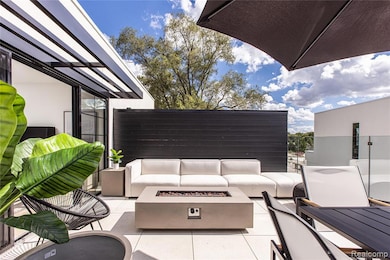View of patio / terrace featuring an outdoor living space with a fire pit