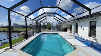 Outdoor pool featuring enclosure, a patio area, an