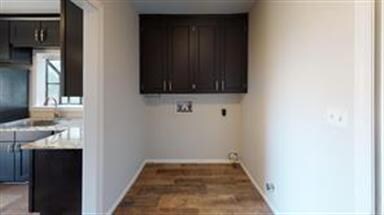 Laundry Room with storage right off kitchen.