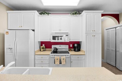 Kitchen with tile patterned floors, white applianc