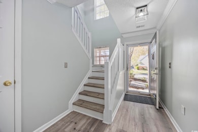 Foyer entrance featuring wood finished floors, vis