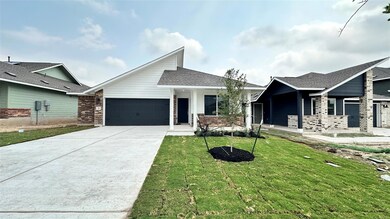 View of front facade featuring a garage, concrete