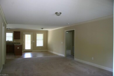 Den looking towards the dining area and kitchen.