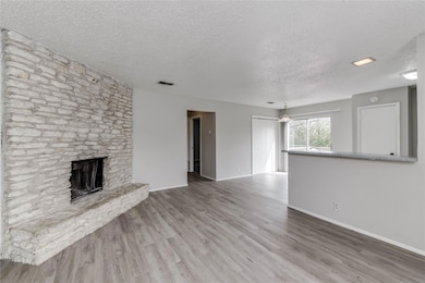 Unfurnished living room with visible vents, wood 