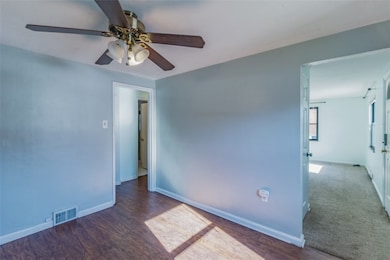 Dining room off of kitchen with hardwood flooring