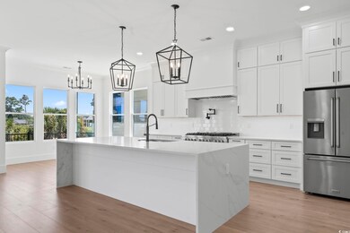 Kitchen with white cabinets, sink, decorative back