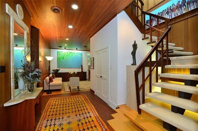 The center hall faces the open stairway to the sec