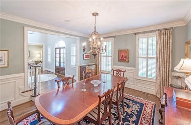 Large dining room with wainscoting and crown moldi