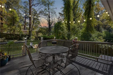 Wooden terrace featuring a fenced backyard and outdoor dining area